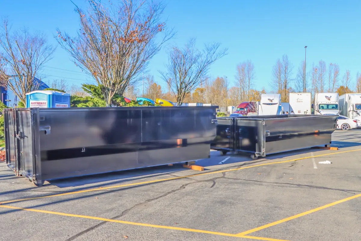 Professional dumpster rental service with roll-off container on residential driveway in Dumfries